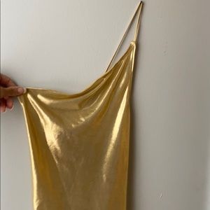 One shoulder gold dress.